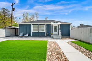View of front of property with board and batten siding, a shingled roof, and a carport