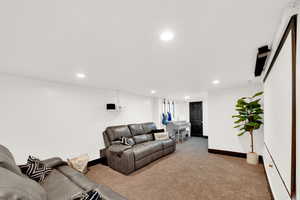 Carpeted living area featuring recessed lighting