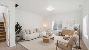 Living room with light colored carpet and stairs