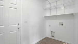 Laundry room with light tile patterned flooring, hookup for an electric dryer, and washer hookup