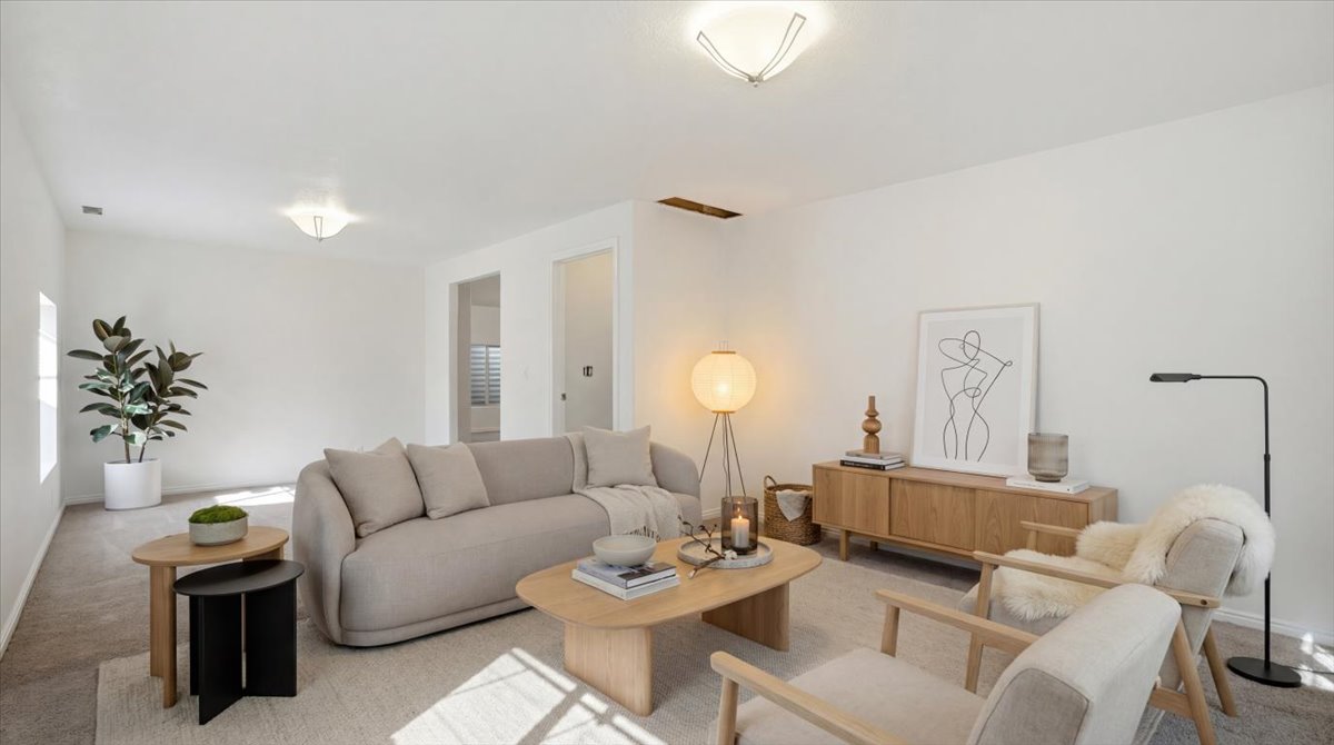 Carpeted living area featuring baseboards