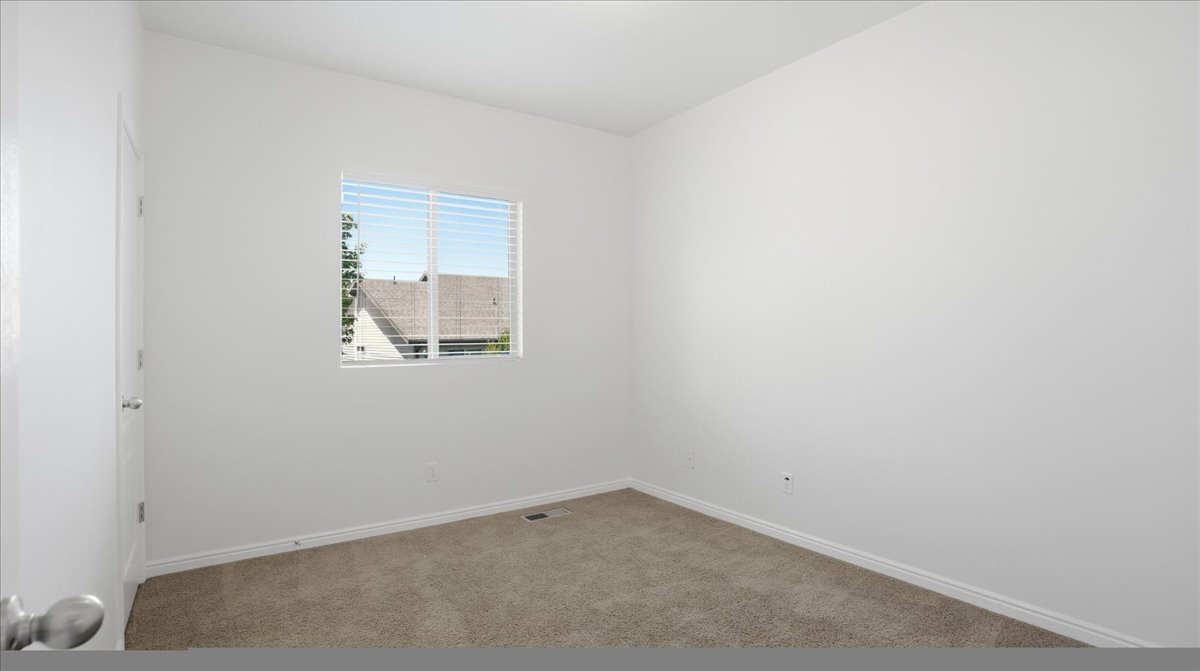 Neutral-toned carpeting and white baseboards