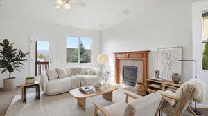 Carpeted living area with a fireplace and a ceiling fan