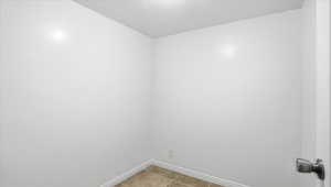 Spare room with baseboards and light tile patterned floors