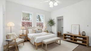 Bedroom featuring carpet, ceiling fan, and a walk in closet