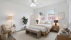 Carpeted bedroom with a ceiling fan and baseboards