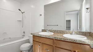Bathroom with double vanity and tub / shower combination