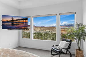Carpeted bedroom with a mountain view and baseboards