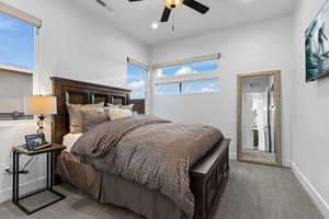 Carpeted bedroom featuring a ceiling fan and recessed lighting