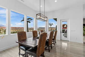 Dining space featuring light wood finished floors and suspended lighting