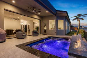 Swimming pool featuring a fire pit and a patio area