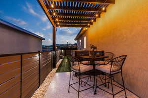 Balcony with outdoor dining area and a putting area