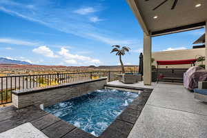 View of swimming pool featuring a hot tub, area for grilling, a mountain view, and patio surround