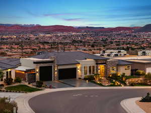 Prairie-style home with stone siding, an attached garage, and a mountain view