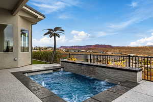View of pool featuring a swimming pool, a jacuzzi, a fenced backyard, a residential view, and patio surround