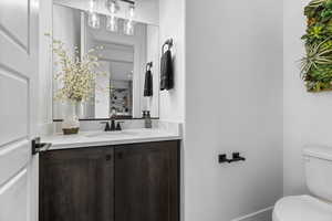 Half bath featuring vanity and toilet