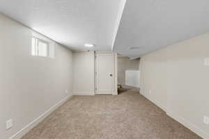 basement family room with stackable washer and dryer closet