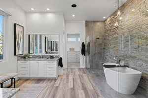 Bathroom with vanity, walk in shower, a soaking tub, light wood-style floors, and recessed lighting