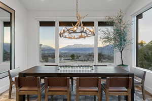 Dining area with a mountain view and a chandelier