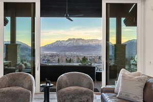 Living area featuring a mountain view, plenty of natural light, and ceiling fan
