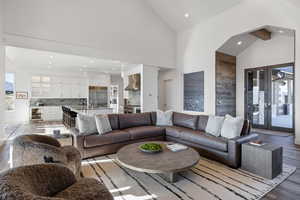 Living room with vaulted ceiling, recessed lighting, light wood-style flooring, and wine cooler