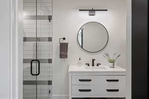 Bathroom featuring vanity and a stall shower