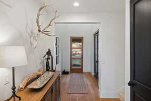 Foyer with light wood-style flooring and recessed lighting