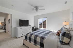 Bedroom with light carpet and ceiling fan