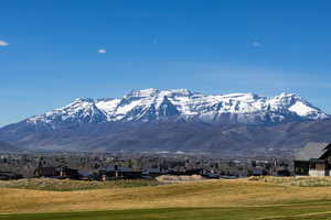 View of mountain backdrop featuring nearby suburban area