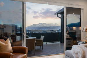 Living area with a mountain view and light wood-style floors