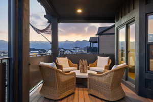 Wooden terrace featuring a mountain view and an outdoor living space