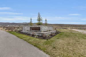 Community / neighborhood sign with a mountain view