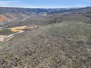 Aerial overview of property's location with a mountain backdrop and rural landscape