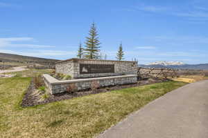 Community sign with a mountain view