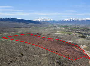 View of rural area featuring a mountain backdrop and property boundaries highlighted