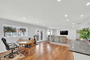 Daylight basement Dining room featuring light wood finished floors and recessed lighting