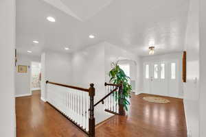 Foyer with wood floors and recessed lighting