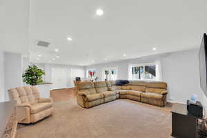 9 ft basement ceilings, Living room with light colored carpet and recessed lighting