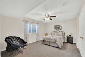 Carpeted bedroom with baseboards and ceiling fan
