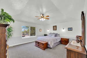 Primary Bedroom with light colored carpet and a ceiling fan