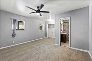 Unfurnished bedroom featuring a closet, light carpet, and a ceiling fan