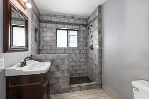 Bathroom featuring vanity and tiled shower