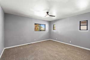 Empty room featuring carpet and ceiling fan