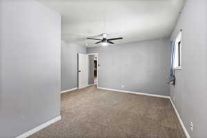 Unfurnished room featuring ceiling fan and carpet flooring
