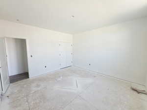 Unfurnished bedroom with baseboards and a closet