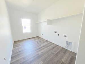 Laundry area with light wood-style flooring and washer hookup