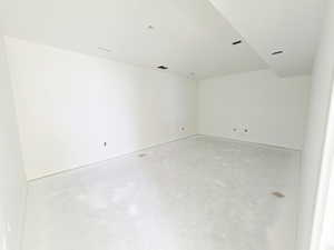Unfurnished room featuring concrete flooring