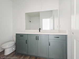 Full bath with vanity and dark wood finished floors