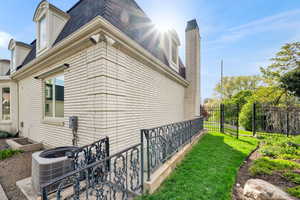 View of side of property with brick siding and a chimney