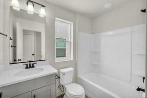 Bathroom featuring vanity and  shower combination